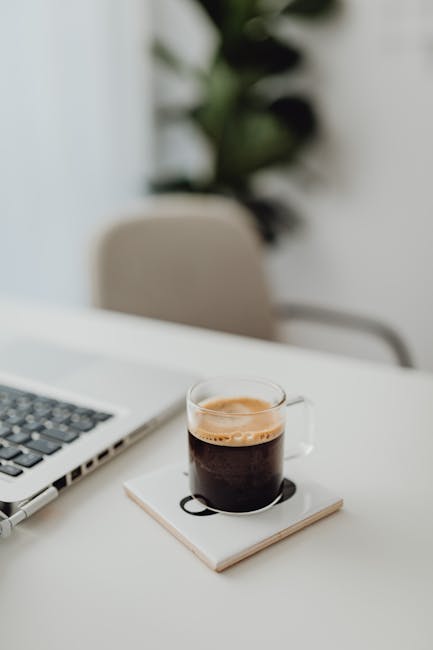 A professional working at a modern, clean desk taking a short mindful break.